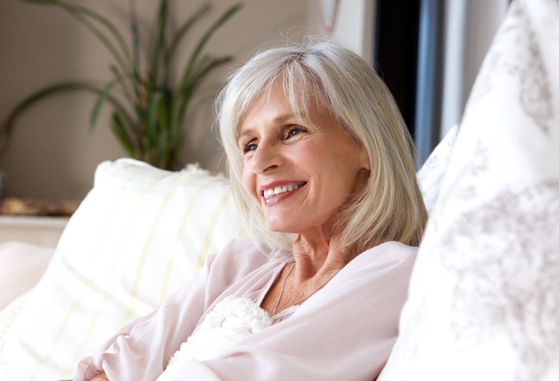 700 happy-older-woman-sitting-couch